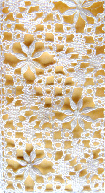 close up image of lace insert on baby gown