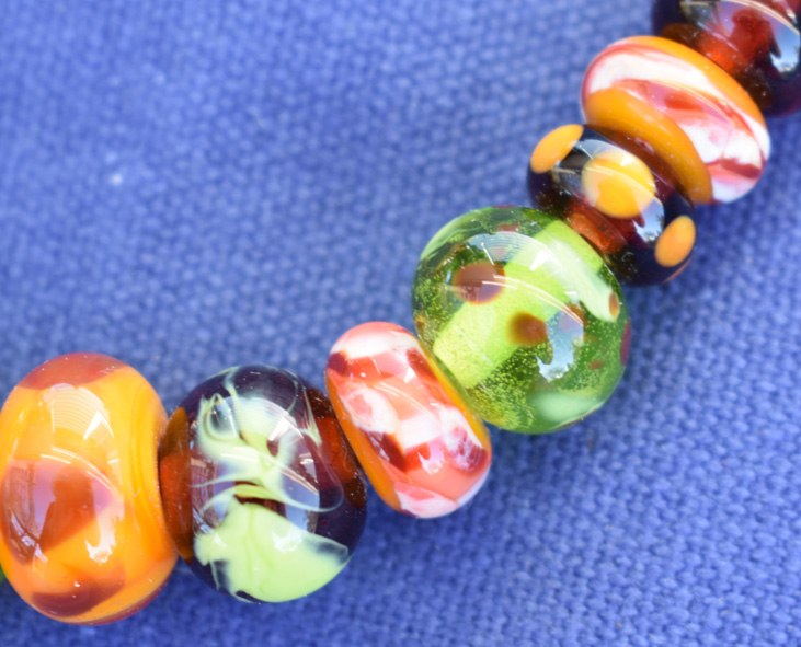 close up of necklace clasp with handmade glass beads